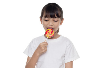 Cute Asian child enjoying a sweet treat. This happy little girl is eating a colorful rainbow...