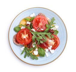Tasty salad with arugula, cheese, tomatoes, nuts and prosciutto isolated on white, top view