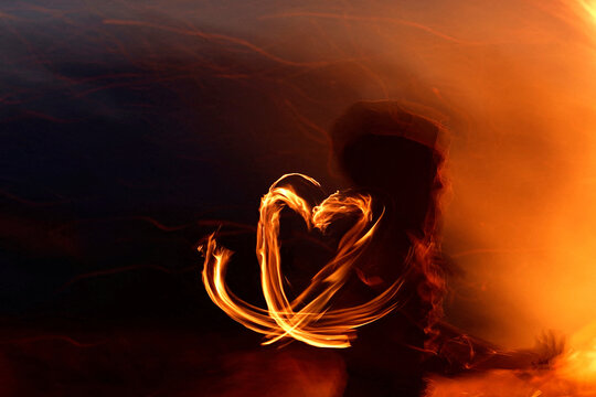 Fiery heart shape created with fire, abstract, long exposure photography.  Romantic, passionate, intense.