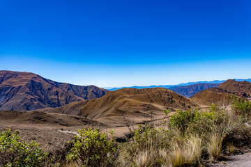 Scenic dry landscape of rolling hills and distant mountains in the beautiful region of Salta, Argentina.