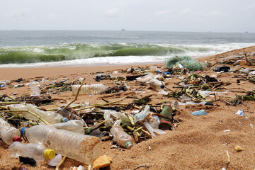 Ocean pollution plastic waste on sandy beach shoreline