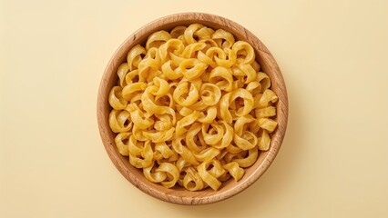 Curly fusilli pasta displayed in a wooden bowl atop a muted yellow setting