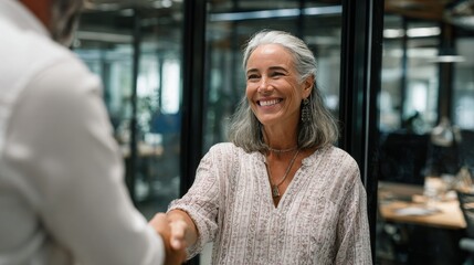 Happy mature professional business woman handshaking partner in office, Successful conclusion of a contract, agreement, 16:9