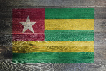 Togo flag on rustic old wood surface background