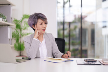 Asian adult businesswoman professional working thinking planning strategizing in modern office...