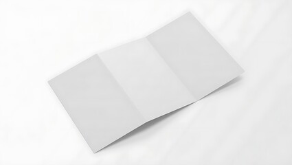 A blank white trifold brochure or leaflet unfolded and isolated on a white background from a high angle