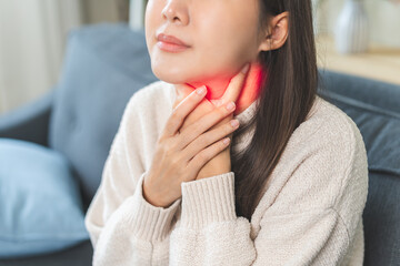 Sickness in inflaming asian young woman, girl use hand check self touch at sore throat, pain...