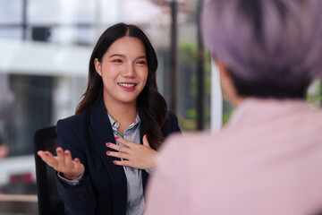 Asian professional adult woman smiling confident during business interview meeting explaining new...
