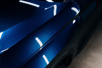 Close-up of blue SUV fender and door with glossy ceramic coating – perfect reflections and clean...