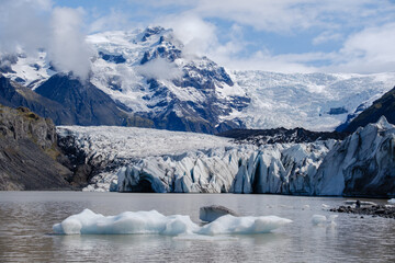 Explore the grandeur of Svinafellsjokull Glacier, its icy formations towering against the rugged...