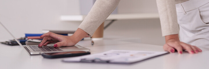 Adult professional hands typing laptop computer creating business reports analyzing data modern...
