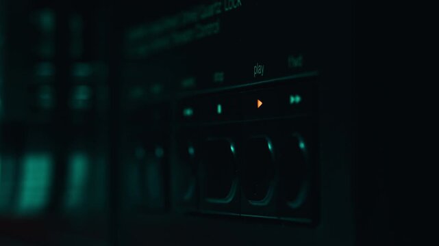 Man pressing stop button on retro tape machine in studio closeup. Index touching