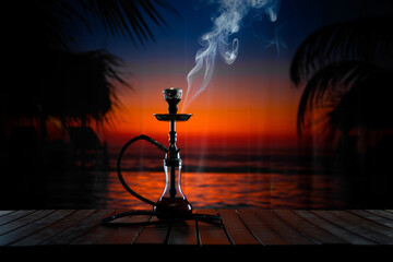 An oriental hookah releases wisps of smoke against a seaside sunset backdrop. Silhouetted palm branches frame the view as the hookah rests on a wooden table in the open night air