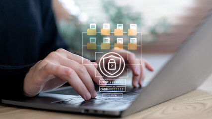 Hands typing on a laptop with a secure login system, file folder network, and password...