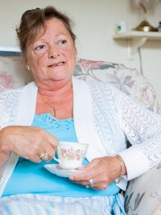 Retirement: Candid Conversation. A senior lady enjoying a cup of tea and a chat. From a series of...