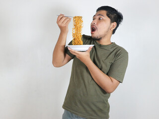 Handsome Asian man is eating noodles with gusto. eating lunch concept. isolated white background