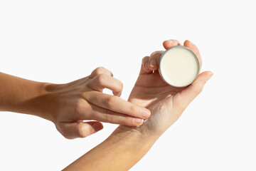 Applying balm on girl hand on white background