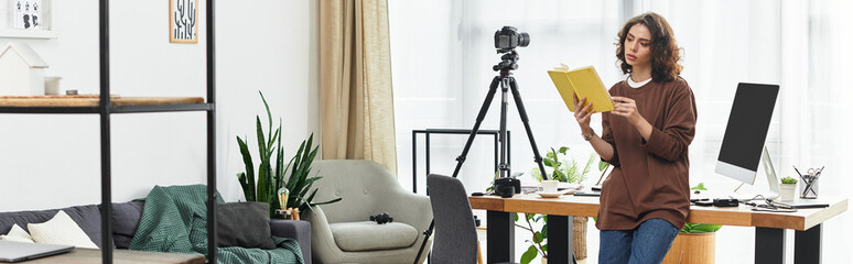 Young woman engaged in creative work at home while reading and planning her next project