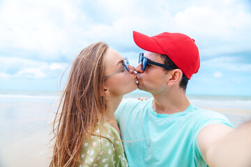 Romantic Couple Kissing on Beach, Caucasian Man and Woman in Love Sharing Affectionate Moment on Summer Vacation by the Sea