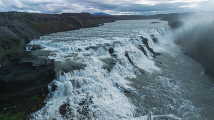 Gullfoss Waterfall showcases its majestic beauty as torrents of water plunge dramatically into the canyon below.