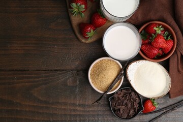 Different ingredients for panna cotta. Milk, sugar, vanilla, chocolate and strawberries on wooden table, flat lay. Space for text