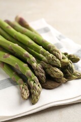 Fresh raw asparagus on light grey table, closeup