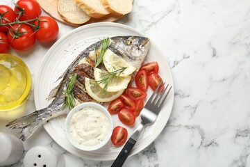 Tasty roasted dorado fish with bread, sauce, tomatoes and lemon on white marble table, flat lay and space for text. Homemade seafood dish