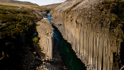 Nestled in Iceland, the majestic Studlagil Canyon features towering basalt columns and a...
