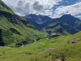 Majestic Mountain Landscape: An awe-inspiring vista of rolling green hills and rugged mountain...