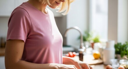 Woman preparing healthy meal in bright kitchen with natural sunlight