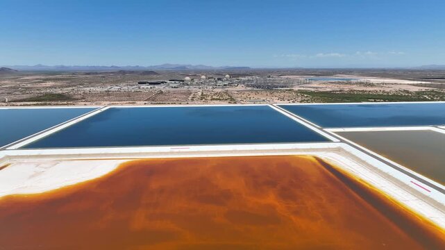 Aerial view of Palo Verde Generating Station showing the cooling ponds reflecting the sky's blue hues contrasted by the desert landscape, Tonopah, Arizona, United States.
