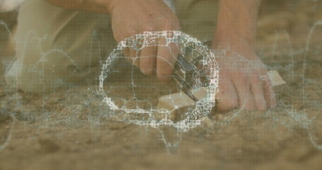 Hands carving soil with hand tool in dry sandy cracked earth outdoors, with wireframe grid overlay
