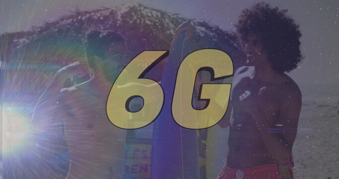 Standing surfers in board shorts holding surfboards with beach waves, lens flare, golden 6G overlay - Powered by Adobe