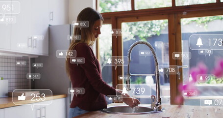Woman rinsing dishes under pull-down faucet at kitchen sink with social media overlays, copy space