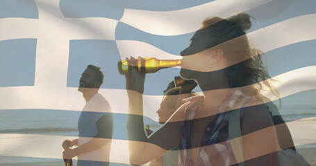 Walking friends holding beer bottles, sporting shoulder bag on beach at sunset, with flag overlay