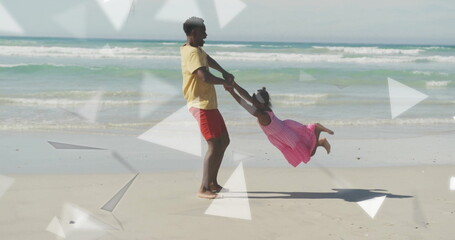Swinging father in yellow shirt and daughter in pink dress at shoreline, with translucent overlays