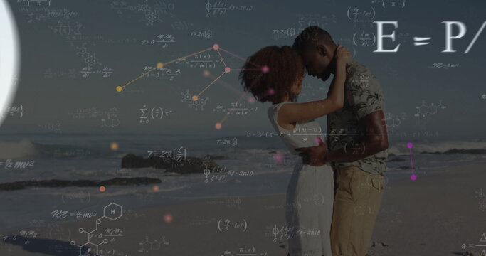 Embracing couple in summer clothing standing on sandy beach, with math and molecular overlays