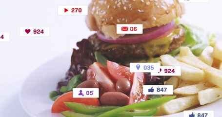 Displaying sesame bun burger melting cheese with fries and fresh salad on white table, social icons