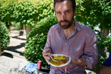 Eating Traditional Paella in a Lush Spanish Village Setting During Festivities
