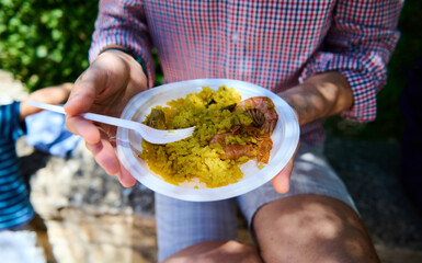 Outdoor Festival in Spanish Village with People Enjoying Holiday with Paella