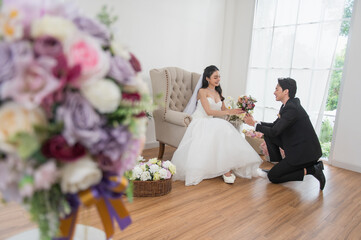 Asian couple getting married, Happy Asian couple in wedding attire, Bride wearing a beautiful white...