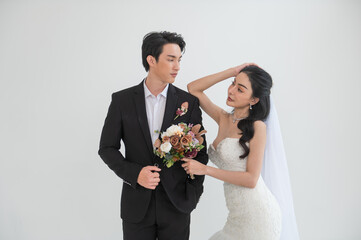 Asian couple getting married, Happy Asian couple in wedding attire, Bride wearing a beautiful white...