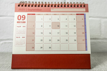 Calendar for September 2025. A desktop calendar for planning on the table.