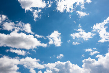 Bright blue sunny sky with clouds, nature background