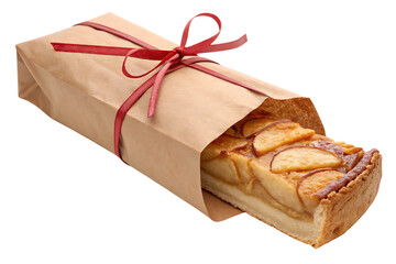 Wrapped apple bread loaf in brown paper bag tied with red ribbon, isolated on a transparent background