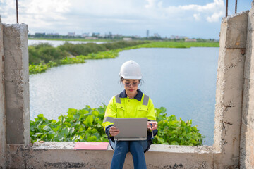 Environmental engineers work at the water storage plant, check the pH of the water, check the...