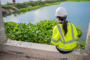 Environmental engineers work at the water storage plant, check the pH of the water, check the...