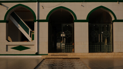 Exterior Of A Mosque With Archways And Decorative Tiles