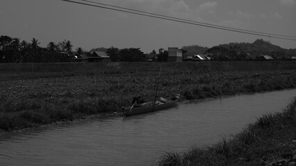 Gray Scale Canal Scenery With Boat