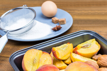 Ripe peaches in metal tray.